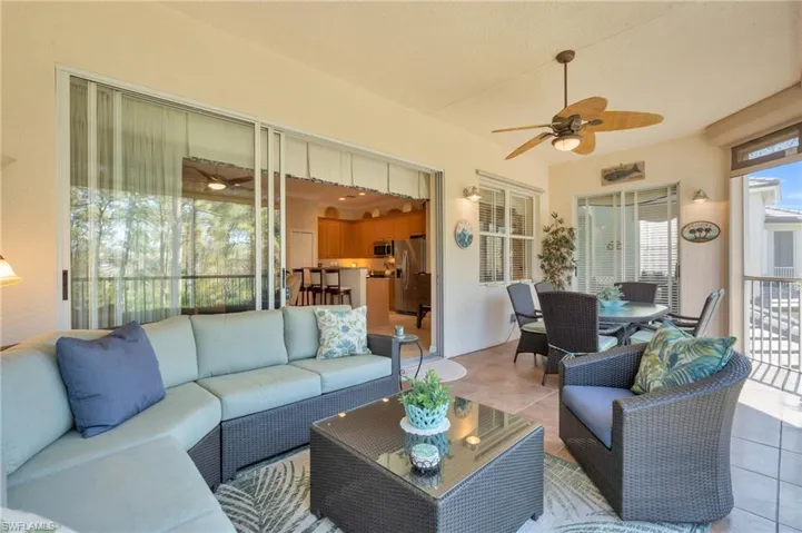 Sunroom with outdoor dining space, a ceiling fan, and an outdoor living space