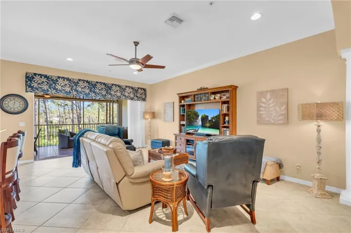 Living area featuring recessed lighting, light tile patterned flooring, ceiling fan, and crown molding