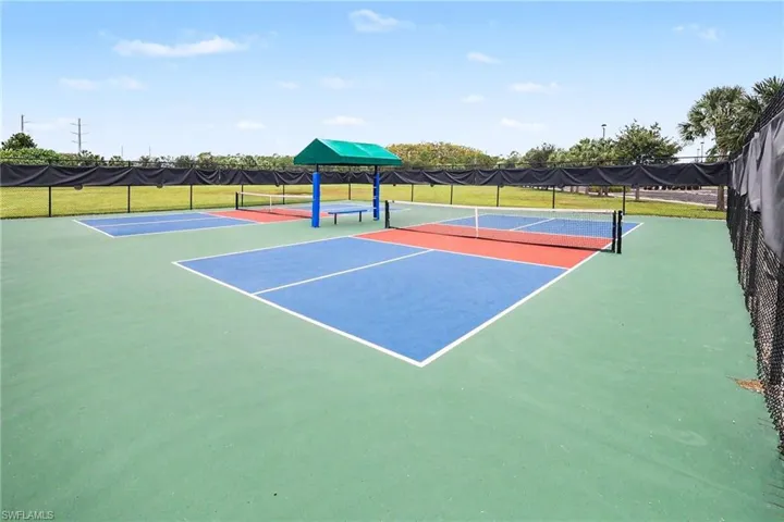 Multiple courts with painted blue and red playing surfaces