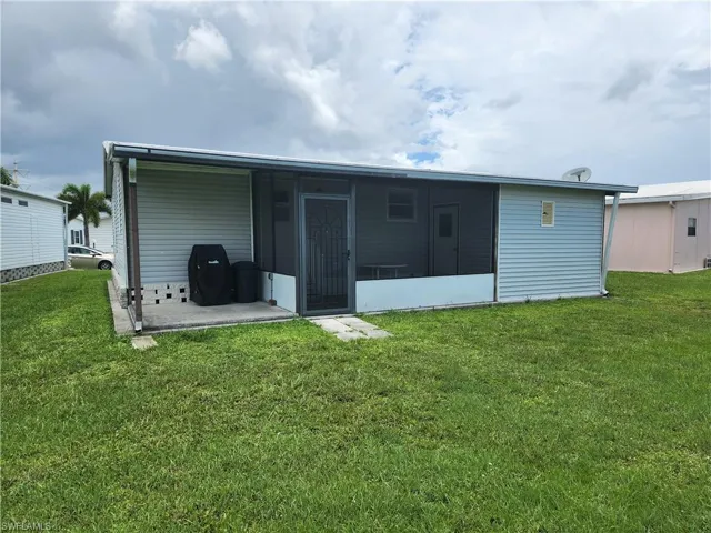Back of house featuring a patio area and a yard