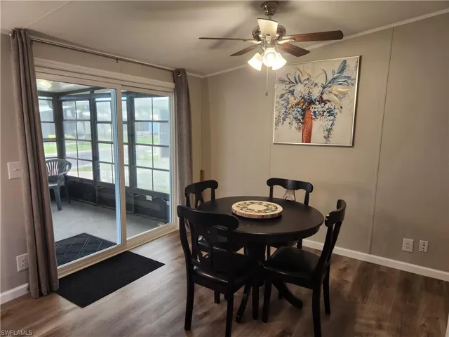 Dining space with crown molding, ceiling fan, and hardwood / wood-style floors