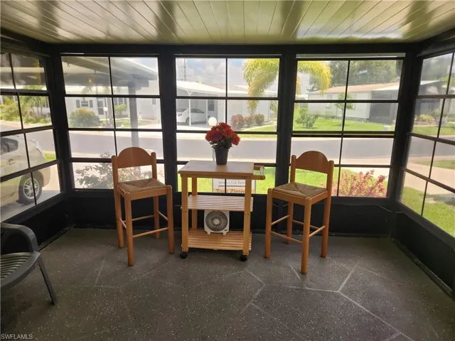 Sunroom with plenty of natural light and wood ceiling