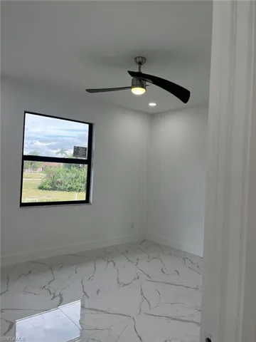Unfurnished room featuring tile flooring and ceiling fan
