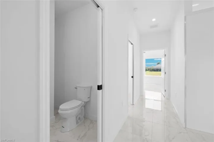 Bathroom featuring toilet and tile floors