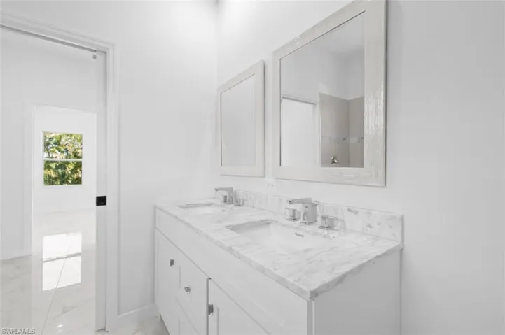 Bathroom featuring tile flooring and double vanity