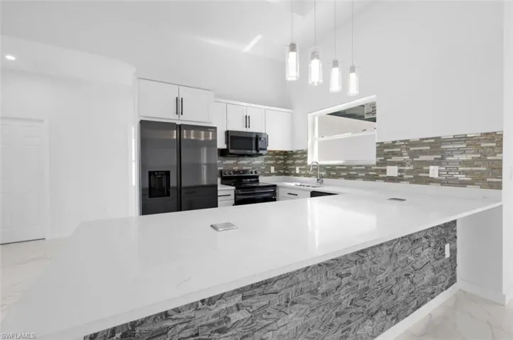 Kitchen with white cabinetry, electric stove, refrigerator with ice dispenser, tasteful backsplash, and light tile floors