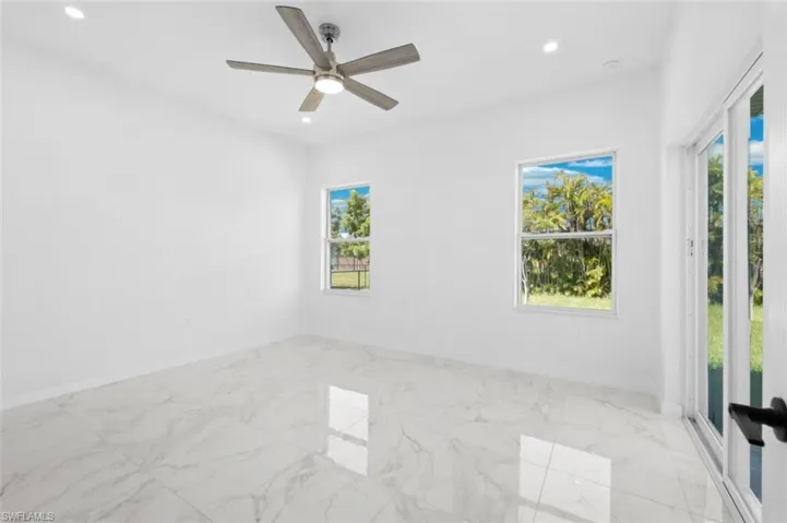 Spare room featuring ceiling fan and light tile floors