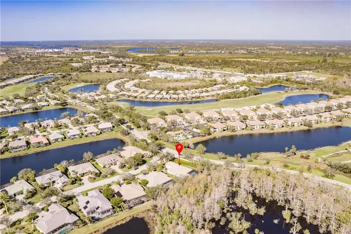 Expansive community featuring multiple water bodies, lush green spaces, and numerous residential properties