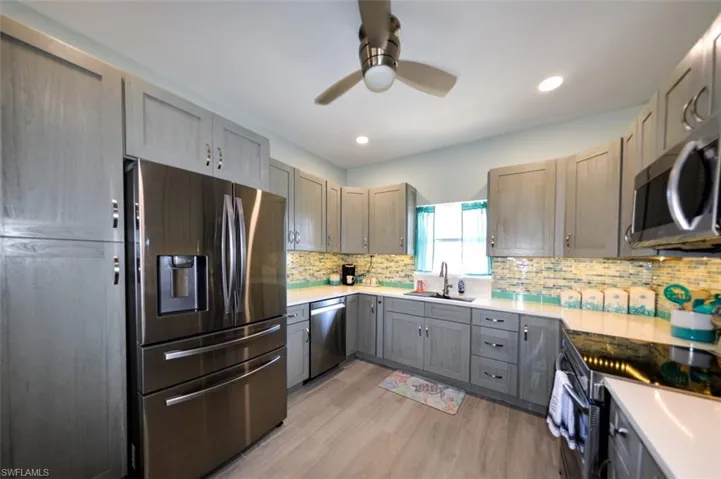 28 CU. FT. 4-DOOR SAMSUNG FRENCH DOOR REFRIGERATOR WITH FLEX ZONE DRAWER.  UPDATED CEILING FAN W/LIGHT.  RECESSED LIGHTING.  BIG PANTRY CABINETS JUST TO LEFT OF REFRIGERATOR.