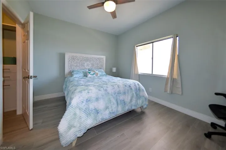 SPACIOUS EASTERN EXPOSURE GUEST BEDROOM.  CUSTOM CABINETRY IN WALK-IN CLOSET.  MODERN CEILING FAN W/LIGHT.