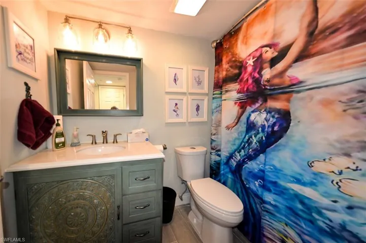 GUEST BATH WITH COMBO TUB/SHOWER.  UPDATED VANITY, MIRROR AND LIGHT FIXTURE.