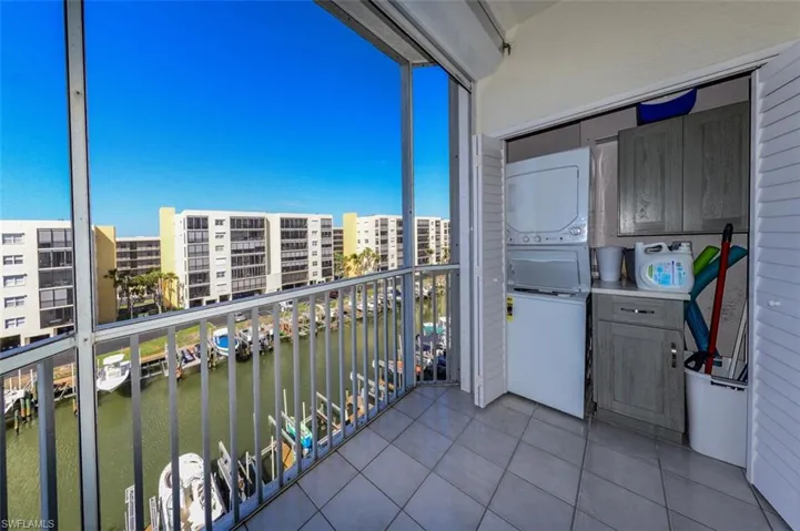 CONVENIENT LAUNDRY CENTER ON LANAI.  2023 STACKED GE WASHER/DRYER.  STORAGE SPACE!