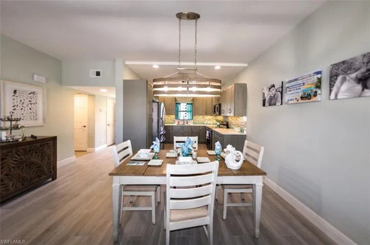 DINING AREA WITH BEAUTIFUL CHANDELIER.  ENTRANCE TO GUEST BEDROOM, GUEST BATH AND UNIT ENTRANCE IS AT LEFT.
