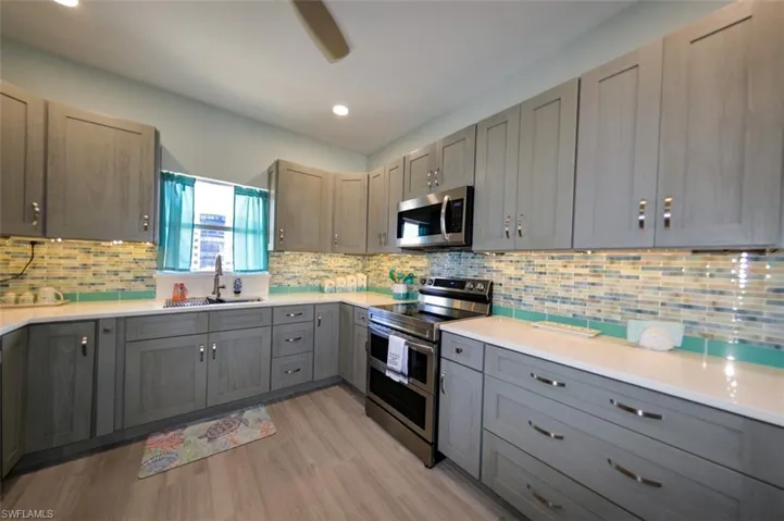 BEAUTIFULLY UPDATED KITCHEN.  NEW CABINETRY.  /FULL HEIGHT TILE BACKSPLASH.  ALL SAMSUNG STAINLESS STEEL APPLIANCES.  RANGE INCLUDES AIR FRYER AND GRIDDLE.  RECESSED LIGHTING.
