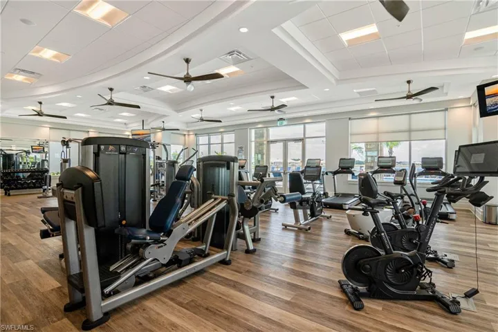Gym with ceiling fan and wood-type flooring
