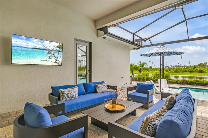 View of patio / terrace with an outdoor living space, a water view, and a lanai