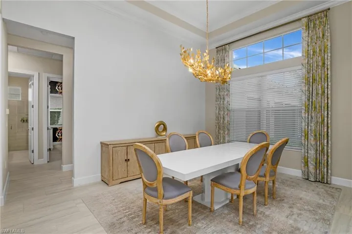 Dining room featuring crown molding and a chandelier