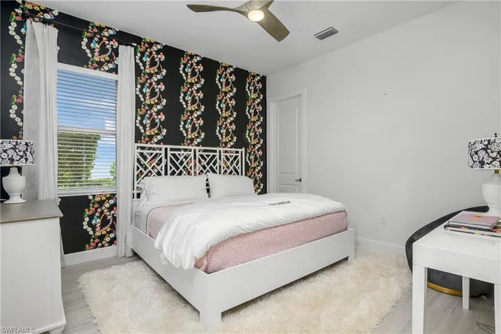 Bedroom featuring ceiling fan and light hardwood / wood-style floors