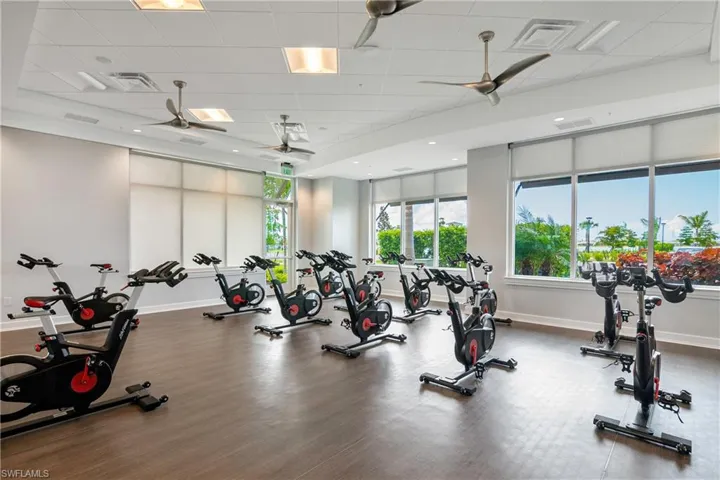 Workout area featuring a paneled ceiling, ceiling fan, and hardwood / wood-style floors