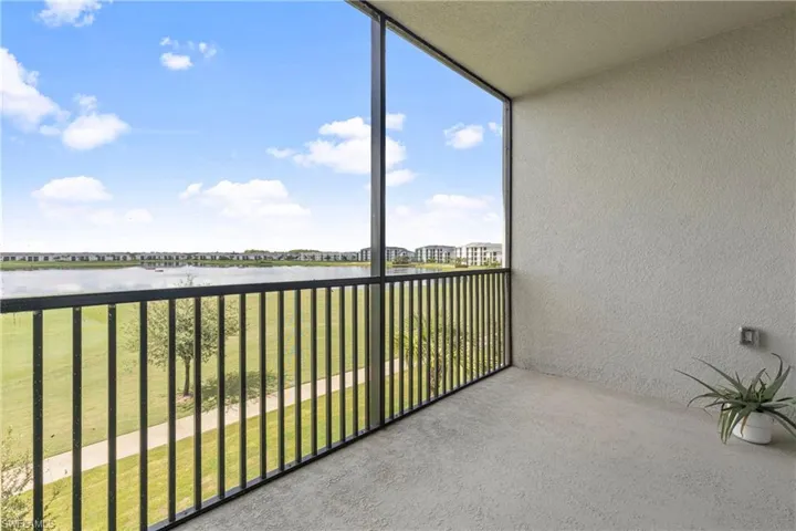 Balcony featuring a water view and a sunroom