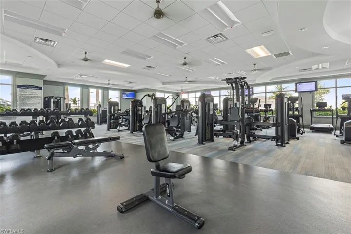 Exercise room featuring a paneled ceiling and a ceiling fan