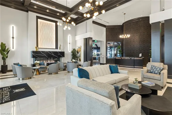 Community lobby with a towering ceiling, coffered ceiling, and beamed ceiling