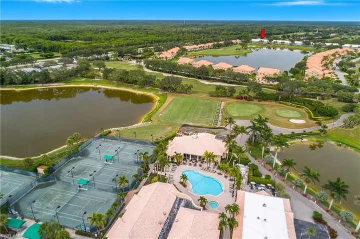 Bird's eye view of a large body of water, a pool area, and a golf course