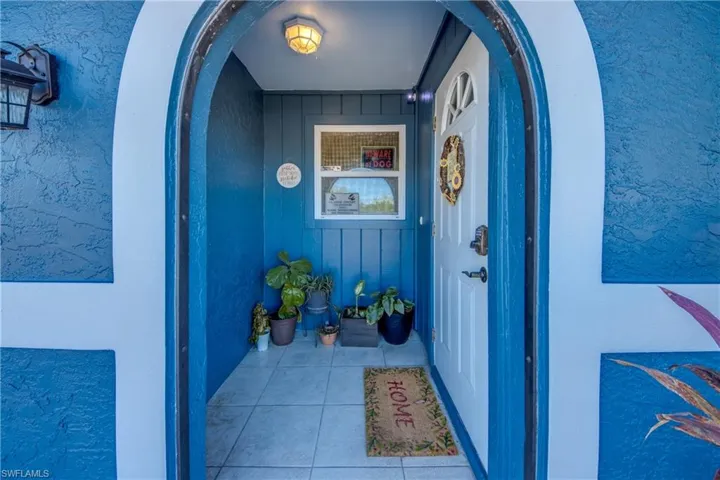 Entrance to property with stucco siding