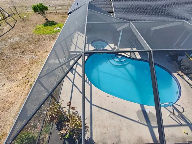 Swimming pool with a lanai and a sunroom