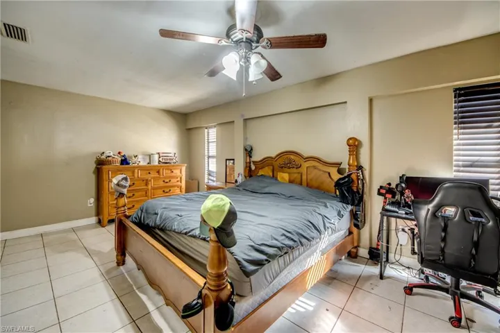 Bedroom featuring light tile patterned flooring and ceiling fan