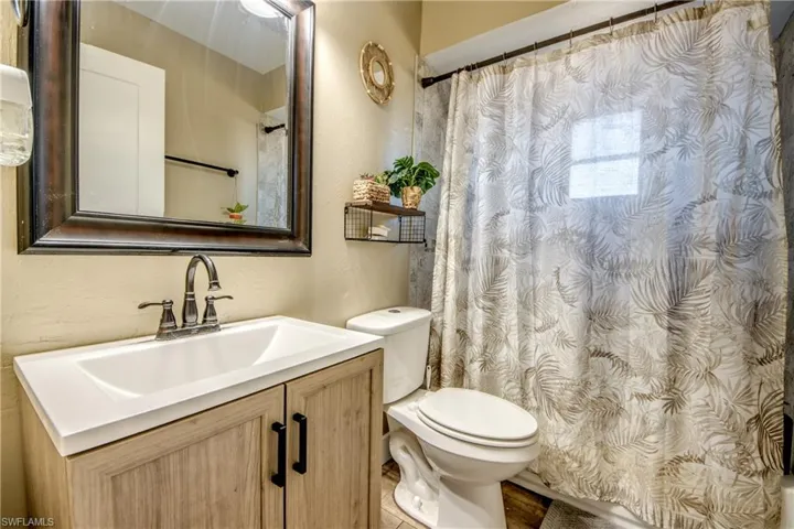 Full bathroom featuring vanity and a shower with curtain