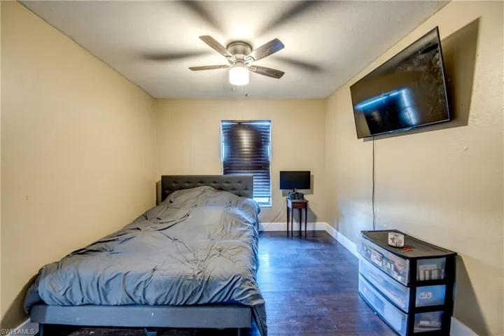 Bedroom featuring dark wood-type flooring and ceiling fan
