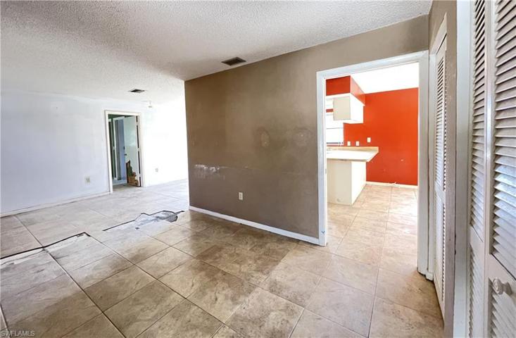 View upon entry. To the left is Living room, center is dining room and master bed door. To the right is kitchen.