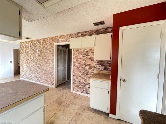 View of pantry on the right and where the fridge would be just tot he left.