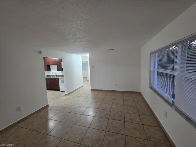 Spare room featuring a textured ceiling and light tile patterned floors