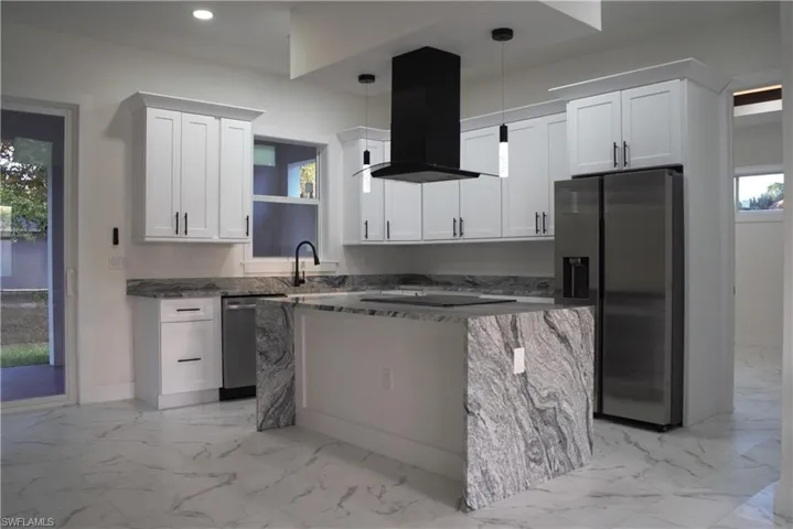 Unfurnished living room with light marble finish flooring, recessed lighting, a raised ceiling, ceiling fan, and french doors