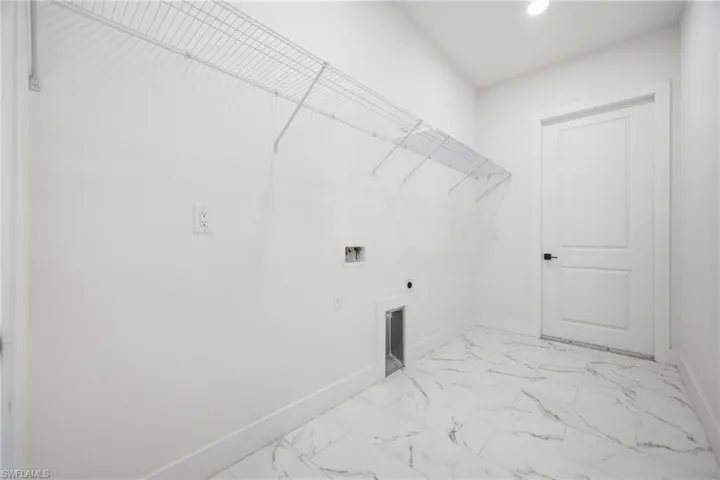 Washroom featuring light marble finish floors, hookup for a washing machine, and electric dryer hookup