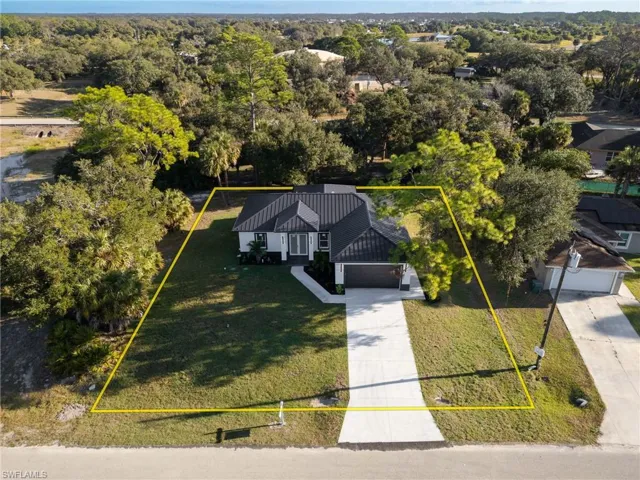 Aerial view of property and surrounding area featuring property parcel outlined