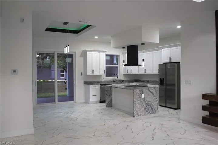Doorway to property with french doors, stucco siding, and a lawn