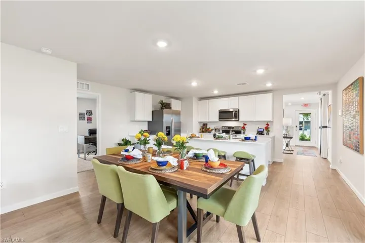 MODEL HOME - Dining area with a desk, light wood-type flooring, and recessed lighting