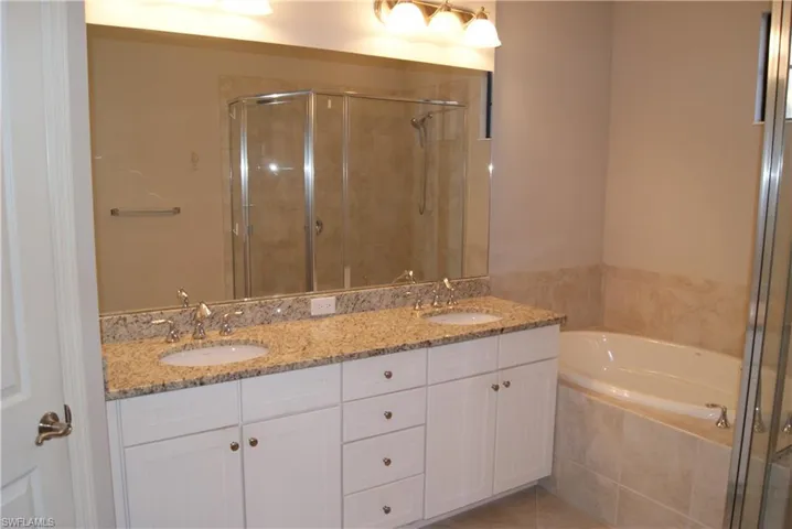 master bath with shower and sepearte tub granite counters