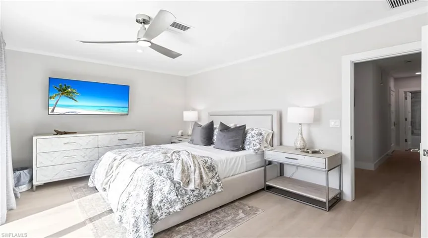 Bedroom with ornamental molding, ceiling fan, and wood finished floors