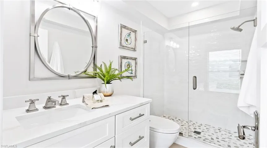 Bathroom with a stall shower and vanity