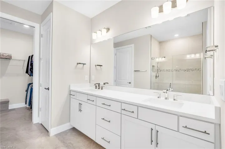 Bathroom featuring vanity and an enclosed shower
