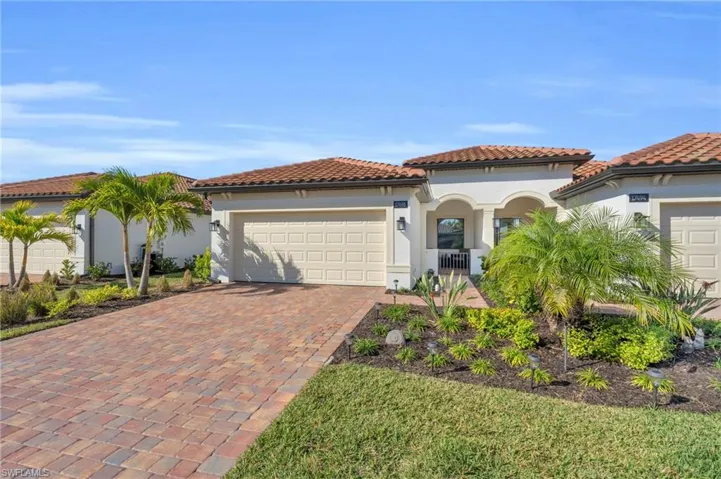 Mediterranean / spanish-style home with a garage