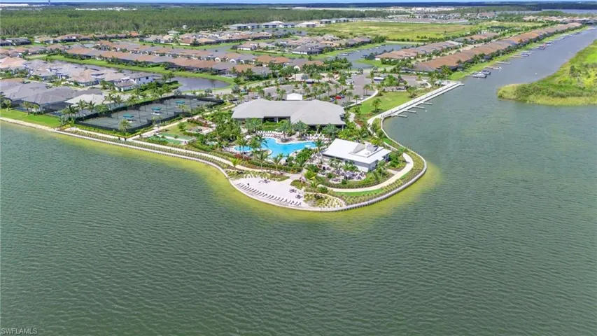 Birds eye view of property with a water view