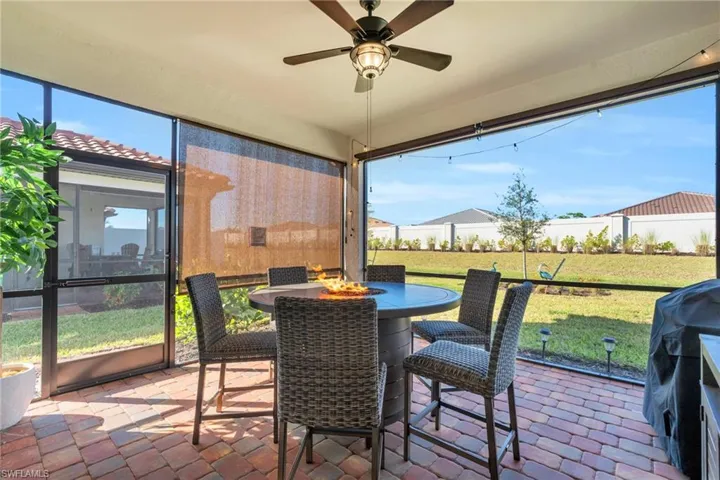 Sunroom / solarium featuring ceiling fan