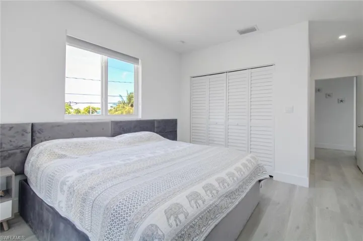 Bedroom with light wood-type flooring and a closet