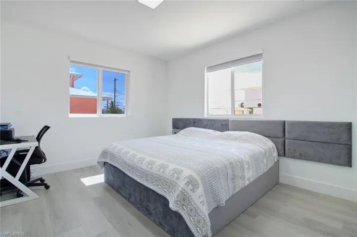 Bedroom featuring light hardwood / wood-style flooring and multiple windows
