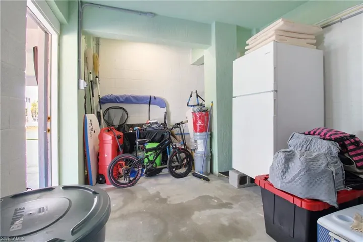 Garage featuring white fridge